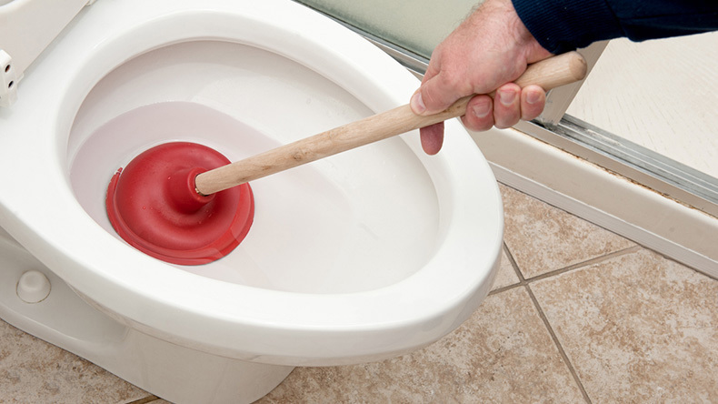 plunging a toilet